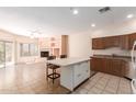 Open-concept living space featuring fireplace, kitchen with island and stainless steel appliances at 16450 E Avenue Of The Fountain Ave # 11, Fountain Hills, AZ 85268