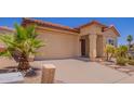Attractive home featuring a well-maintained front yard with desert landscaping elements at 1702 W Amberwood Dr, Phoenix, AZ 85045