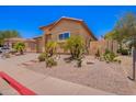 Beautiful home with desert landscaping including palm trees, cacti, and other arid plants at 1702 W Amberwood Dr, Phoenix, AZ 85045