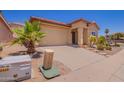Inviting home with desert landscaping and an attached garage in a sunny neighborhood at 1702 W Amberwood Dr, Phoenix, AZ 85045