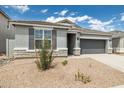 Charming single-story home with gray stucco, stone accents, a two-car garage, and low maintenance landscaping at 17773 W Onyx Ave, Waddell, AZ 85355