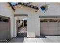 Welcoming courtyard with a wrought iron gate and a glimpse of the front door at 17966 W Agave Rd, Goodyear, AZ 85338