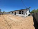 Large backyard featuring block fence and an open canvas for landscaping and outdoor activities at 1835 E Burgess Ln, Phoenix, AZ 85042