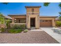 Attractive single-Gathering home featuring a two-car garage, stone accents, and desert landscaping at 20499 W Alsap Rd, Buckeye, AZ 85396