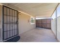 Welcoming covered porch featuring a secure metal gate and ample space for outdoor relaxation and gatherings at 2103 N Silverton St, Mesa, AZ 85203