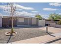 Charming single-story home with a gravel front yard and well-defined landscape features under a partly cloudy sky at 2103 N Silverton St, Mesa, AZ 85203