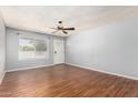 Bright living room boasts wood-look floors, fresh paint, and a front door entrance at 2215 W Straford Dr, Chandler, AZ 85224