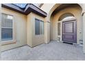 Inviting front porch with brick pavers, arched entryway, and decorative planters at 2830 S Riata Ct, Gilbert, AZ 85295