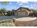 Spacious three-car garage with an extended driveway and desert landscaping at 2830 S Riata Ct, Gilbert, AZ 85295