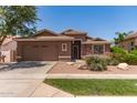 A well-maintained single story home featuring desert landscaping, a two-car garage, and a welcoming front entrance at 3480 E Cullumber Ct, Gilbert, AZ 85234