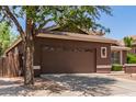 Attached two-car garage featuring a decorative window and a concrete driveway at 3480 E Cullumber Ct, Gilbert, AZ 85234