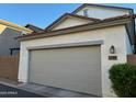 Attached two-car garage featuring a neutral-toned door and an exterior lantern at 3480 E Sheffield Rd, Gilbert, AZ 85296
