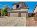 Beige two-story home featuring a three-car garage and well-maintained front yard, blending style and functionality at 3634 N Desert Oasis --, Mesa, AZ 85207