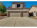 Beige two-story home featuring a three-car garage and well-maintained front yard, blending style and functionality at 3634 N Desert Oasis --, Mesa, AZ 85207