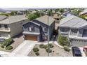 Aerial view of a two-story home featuring a gray stucco exterior and a two-car garage at 36562 W Nina St, Maricopa, AZ 85138