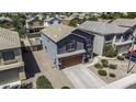 Aerial view of a two-story home featuring a gray stucco exterior and a two-car garage at 36562 W Nina St, Maricopa, AZ 85138