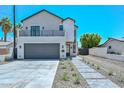 Contemporary two-story home with a balcony, gray garage door, and landscaped front yard at 3831 N 8Th St, Phoenix, AZ 85014