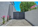 Private gate with flower bushes providing access to backyard at 3831 N 8Th St, Phoenix, AZ 85014