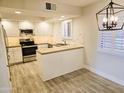 Bright kitchen with updated appliances, granite countertops, and shaker-style cabinets at 4303 E Cactus Rd # 135, Phoenix, AZ 85032
