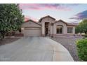 Attractive single-story home featuring a two-car garage, arched entry, and tidy gravel landscaping at 4906 S Verbena Ave, Gilbert, AZ 85298