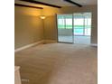 Spacious carpeted living room with sliding glass doors that offer a view of the pool at 6841 E Vista Dr, Paradise Valley, AZ 85253