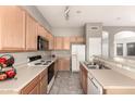 Efficient kitchen with ample counter space, standard appliances, and a peninsula for casual dining at 689 E Stottler Dr, Gilbert, AZ 85296