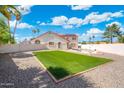 Large backyard with artificial turf area, providing ample space for outdoor activities and enjoyment at 7503 W Julie Dr, Glendale, AZ 85308