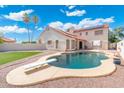 Spacious backyard featuring a refreshing pool and artificial turf for relaxation and entertainment at 7503 W Julie Dr, Glendale, AZ 85308