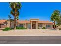 Charming home featuring a tile roof, mature landscaping and desert landscaping for low maintenance at 7722 W Libby St, Glendale, AZ 85308