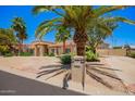 Well-maintained home with mature landscaping, long driveway, and desert landscaping for low maintenance at 7722 W Libby St, Glendale, AZ 85308