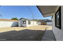 View of the backyard with a dirt landscape, a block wall, and a single-story home at 121 E Monte Way, Phoenix, AZ 85042