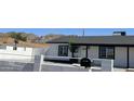 A charming home features a white fence, black trim, and a mailbox near the front door at 121 E Monte Way, Phoenix, AZ 85042
