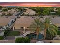 Aerial view of a private backyard featuring an outdoor living space, pool and lush tropical landscaping at 1410 S Los Altos Dr, Chandler, AZ 85286