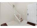 Bright foyer featuring a staircase with white banister and tile flooring that leads to the main living areas at 1502 E Goldcrest St, Gilbert, AZ 85297