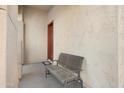 Welcoming covered porch with a comfortable bench and a view of the home's entrance at 1502 E Goldcrest St, Gilbert, AZ 85297
