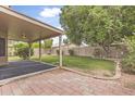 Spacious backyard with covered patio, lush green lawn, and privacy fence at 15235 S 30Th St, Phoenix, AZ 85048