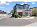 Beautiful two-story home with a modern design, balcony, two-car garage, and landscaped front yard at 1555 E Ocotillo Rd # 16, Phoenix, AZ 85014