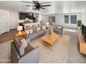 Spacious living room features modern furniture and an open floor plan at 16236 W La Ventilla Way, Goodyear, AZ 85338