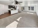 Bright living room offers ample space and seamless flow to the kitchen at 16236 W La Ventilla Way, Goodyear, AZ 85338