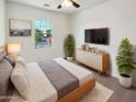 Cozy main bedroom with neutral tones, a large window, and stylish furniture for a relaxing retreat at 19904 W Sherman St, Buckeye, AZ 85326