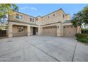 Spacious beige two-story home with a three-car garage and a concrete driveway under a blue sky at 22193 E Via Del Oro --, Queen Creek, AZ 85142