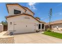 Charming two-story home with a well-manicured lawn, desert landscaping, and a two-car garage at 2934 S Woodruff Cir, Mesa, AZ 85212