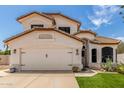 Charming two-story home with a well-manicured lawn, desert landscaping, and a two-car garage at 2934 S Woodruff Cir, Mesa, AZ 85212