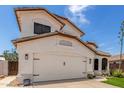 Charming two-story home with a well-manicured lawn, desert landscaping, and a two-car garage at 2934 S Woodruff Cir, Mesa, AZ 85212