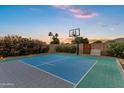 Private sport court surrounded by lush greenery, perfect for basketball and other outdoor activities at 3010 E Fruitvale Ave, Gilbert, AZ 85297