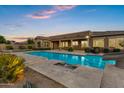 Resort-style pool with baja shelf, water features, slide, and covered patio, ideal for outdoor entertaining at 3010 E Fruitvale Ave, Gilbert, AZ 85297