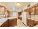 Bright kitchen with white tile countertops, wood cabinets, and a breakfast nook creating a classic, functional space at 325 W Loma Ln, Phoenix, AZ 85021