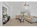 Bright living room with neutral decor, a ceiling fan, and a sliding glass door at 3338 E Lavey Ln, Phoenix, AZ 85032