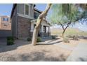 Attractive two-story home with a welcoming front porch, complemented by desert landscaping and picturesque views at 34979 N 30Th Ave, Phoenix, AZ 85086