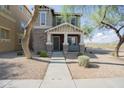 Inviting two-story home with a cozy front porch, showcasing a desert landscape and mountain views at 34979 N 30Th Ave, Phoenix, AZ 85086